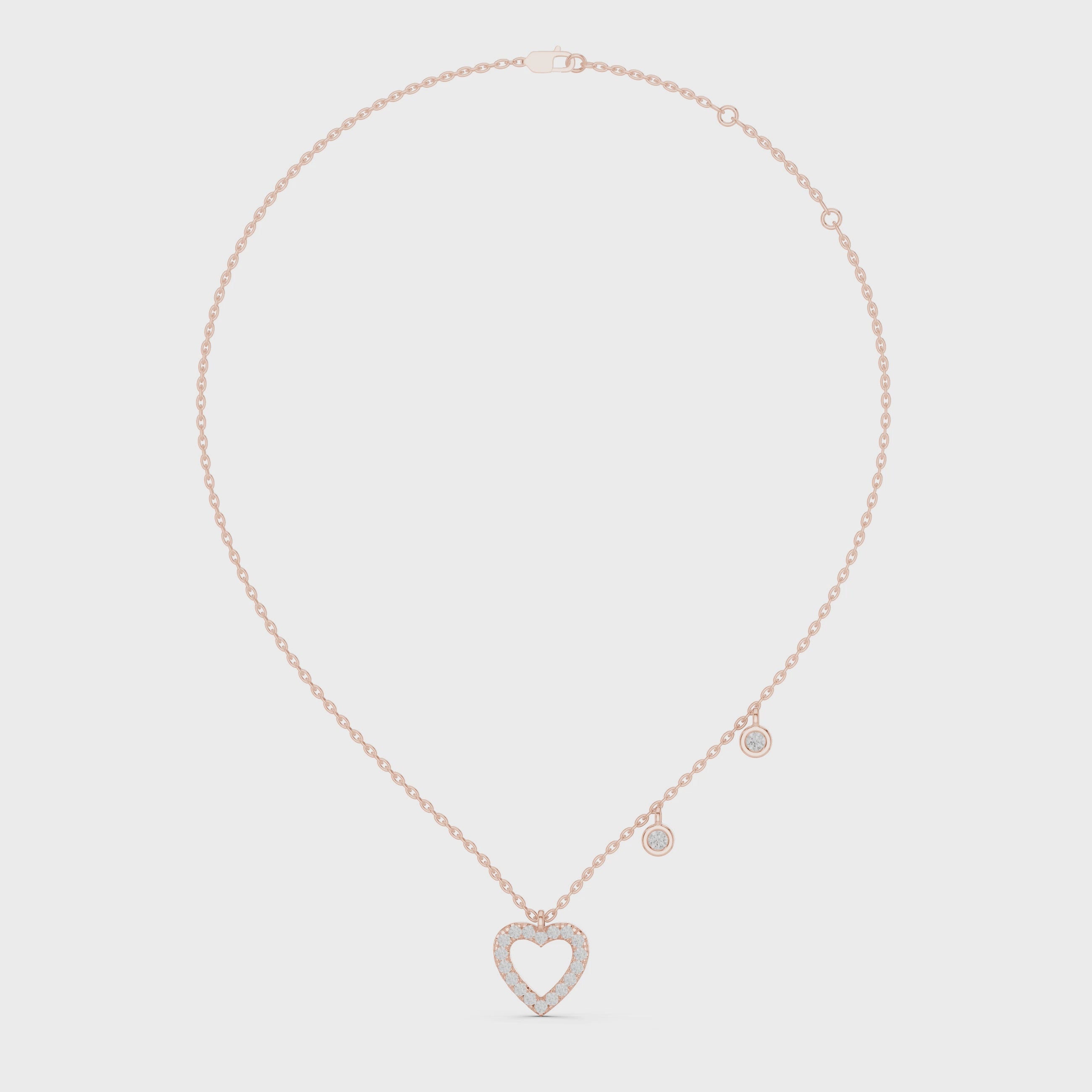 "Rose gold heart-shaped diamond drop pendant necklace with delicate accent charms"