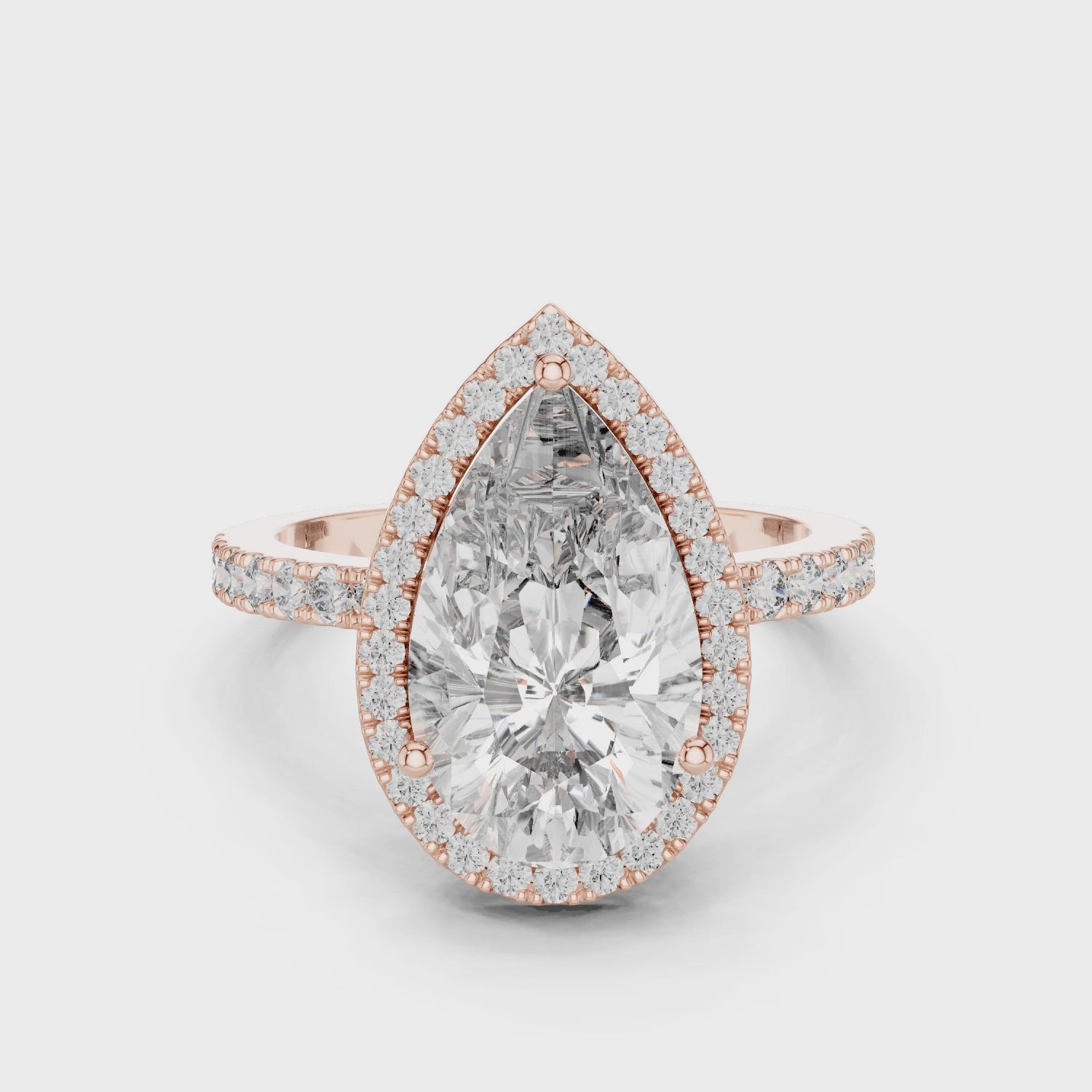 360-degree view of a pear-cut diamond halo engagement ring in rose gold