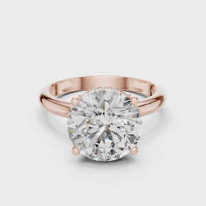 A close-up view of a 3.75 CT round brilliant lab-grown diamond hidden halo engagement ring in 14K rose gold.
