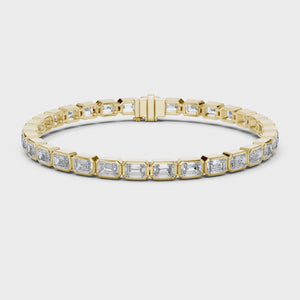 Video of yellow gold emerald cut bezel set diamond tennis bracelet